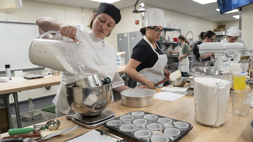 Culinary arts students work in the kitchen lab