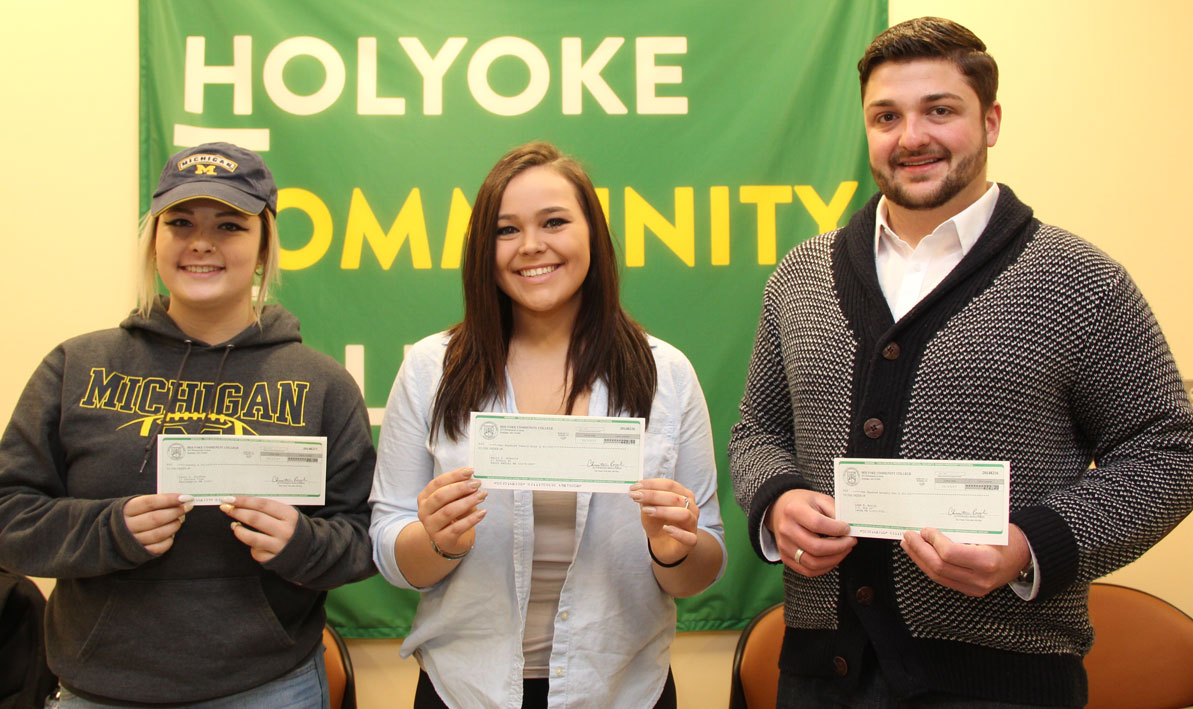 Devon Siefken, Emily Roberts and Adam Bouley hold their Commonwealth Commitment tuition rebate checks.