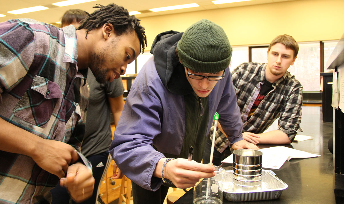 Jhaydan Sheftall, Dylan Kelly and Connor Jacoby build a calorimeter for an experiment in the Cli-Fi class.