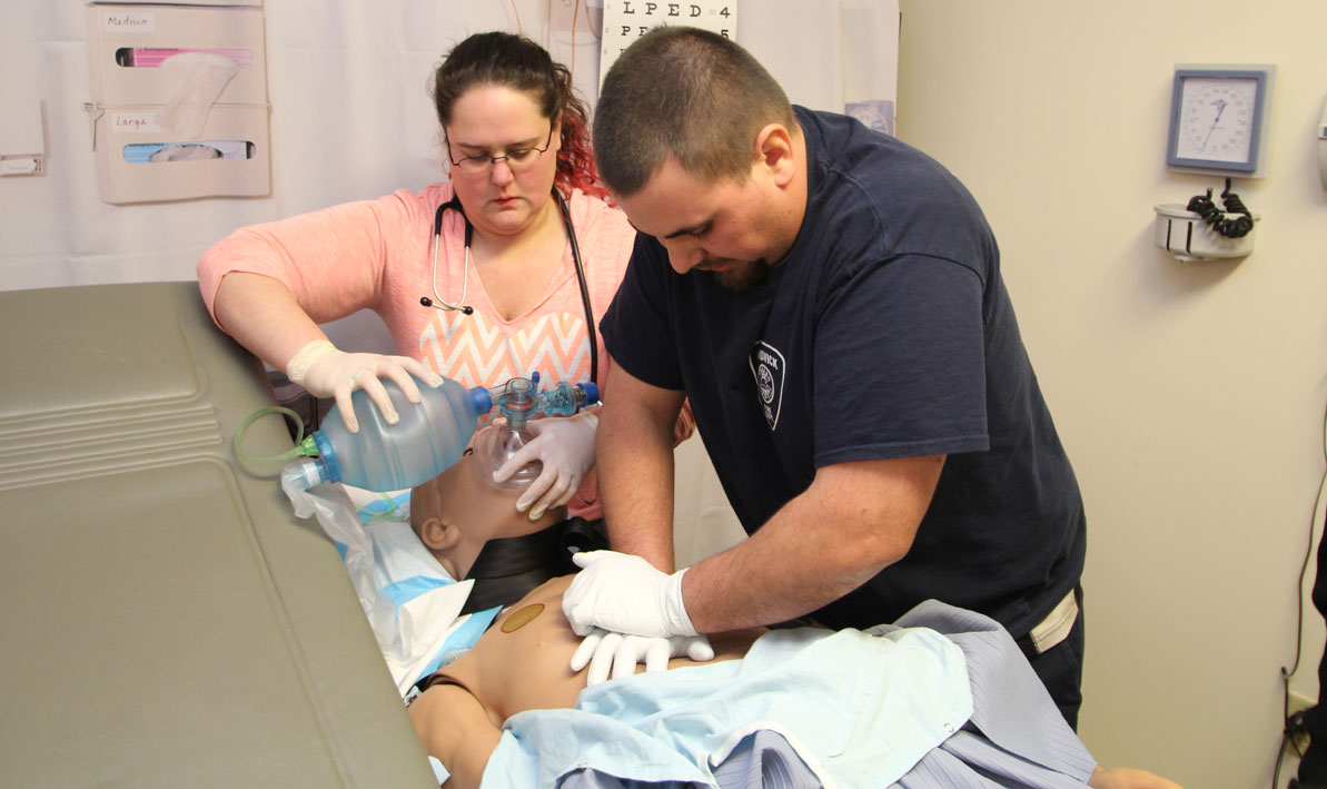 EMT students Bonnie and Justin Cook, from Hardwick, perform CPR on a "patient," during a simulated emergency at Holyoke Community College.