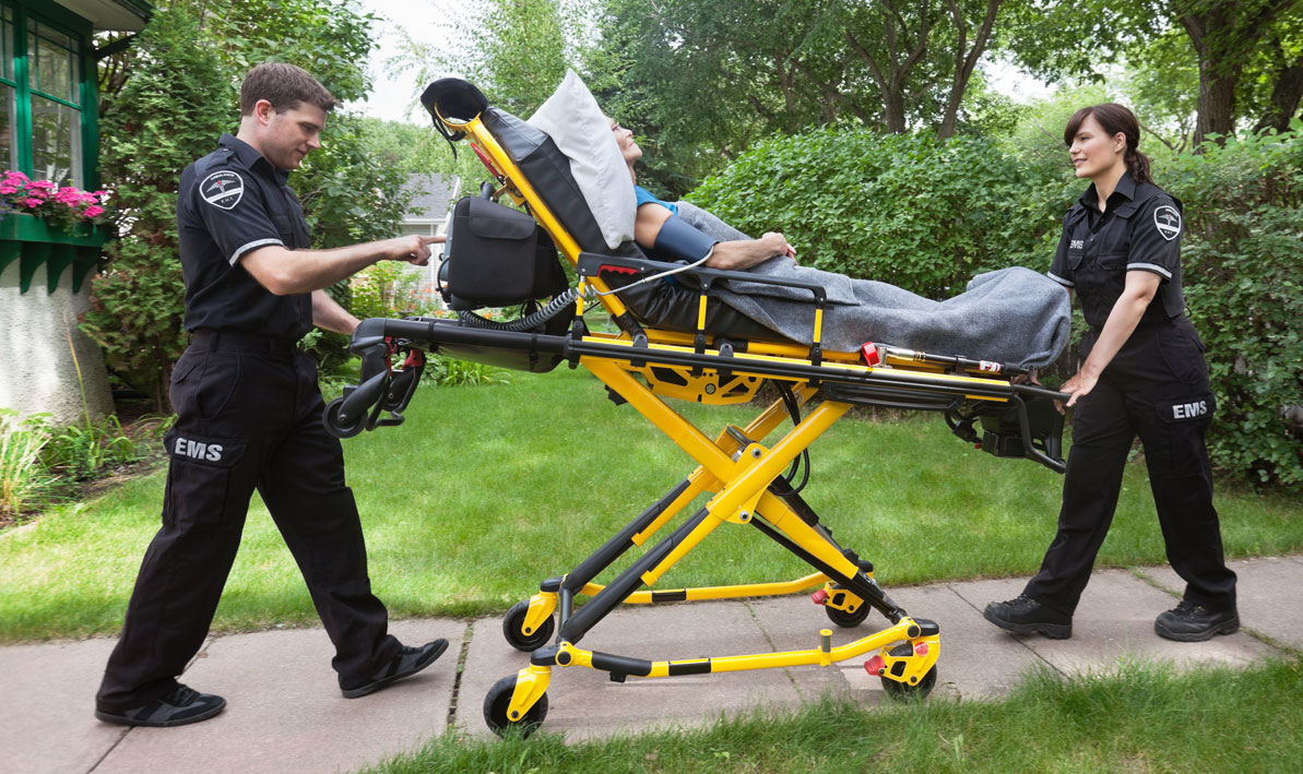 EMTs escort a patient on a stretcher