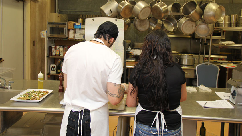 Two students in the program prepare a meal in the Culinary Arts Laboratory kitchen at HCC. 