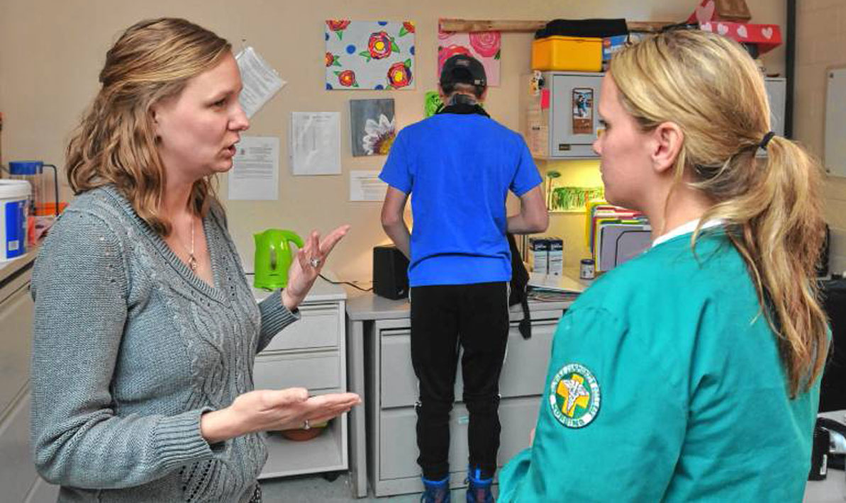 Lindsey Sojkowski, a school nurse at Hampshire Regional, explains the different visits from students to Brittney Kane, a first year nursing student at HCC.
