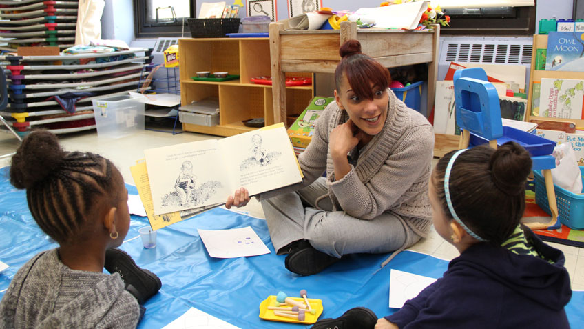 HCC student Cindy Soriano, from Northampton, reads the book Blueberries for Sal during a Literacy Enrichment Day at the Springfield Boys and Girls Club.