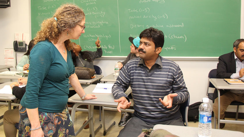 HCC professor Elizabeth Trobaugh meets with visitor from Pakistan