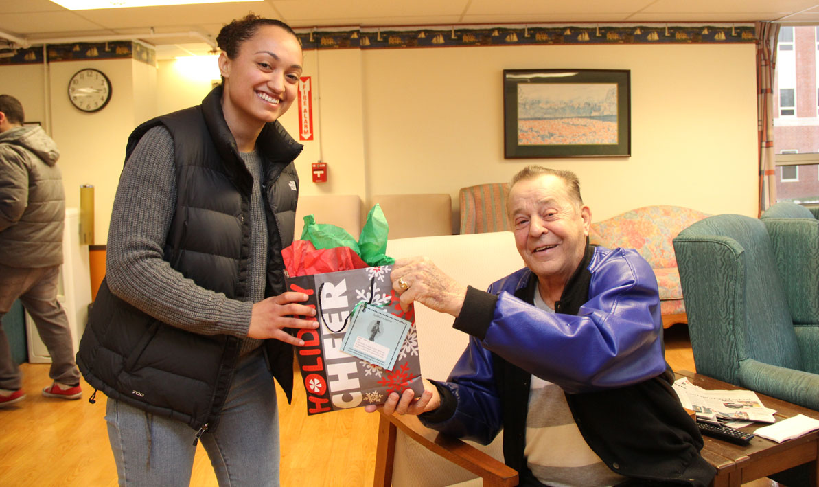 HCC student delivers gifts to Soldiers' Home resident. 