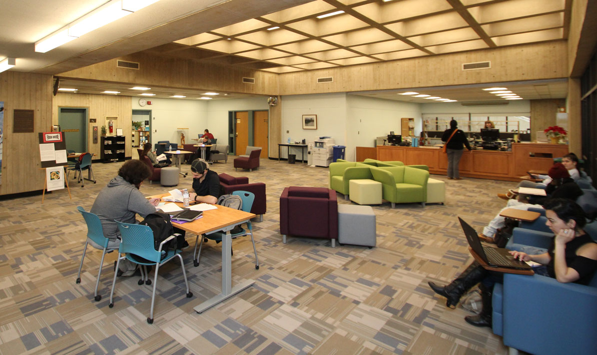 Picture of updated library lobby with new carpet, paint, furniture and circulation desk. 