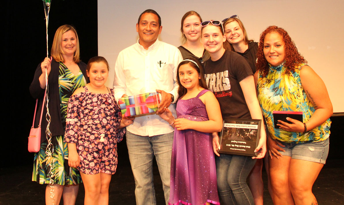 HCC professor Alex Sanchez on the stage of the Leslie Phillips Theater with his wife, daughters and students. 