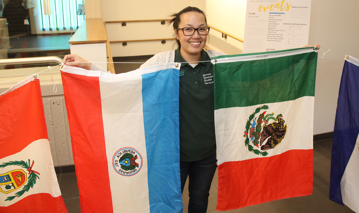  An HCC student holds up flags from Mexico and Paraguay during a Hispanic Heritage Month event on campus in October 2019. 