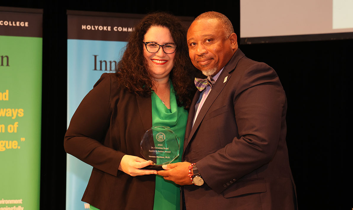 HCC Anthropology Professor Vanessa Martínez accepting the inaugural Dr. Christina Royal Equity and Action Award from HCC President George Timmons.