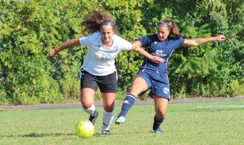 Emma Gomes controls the ball as she shields off a defender in an early season game. 