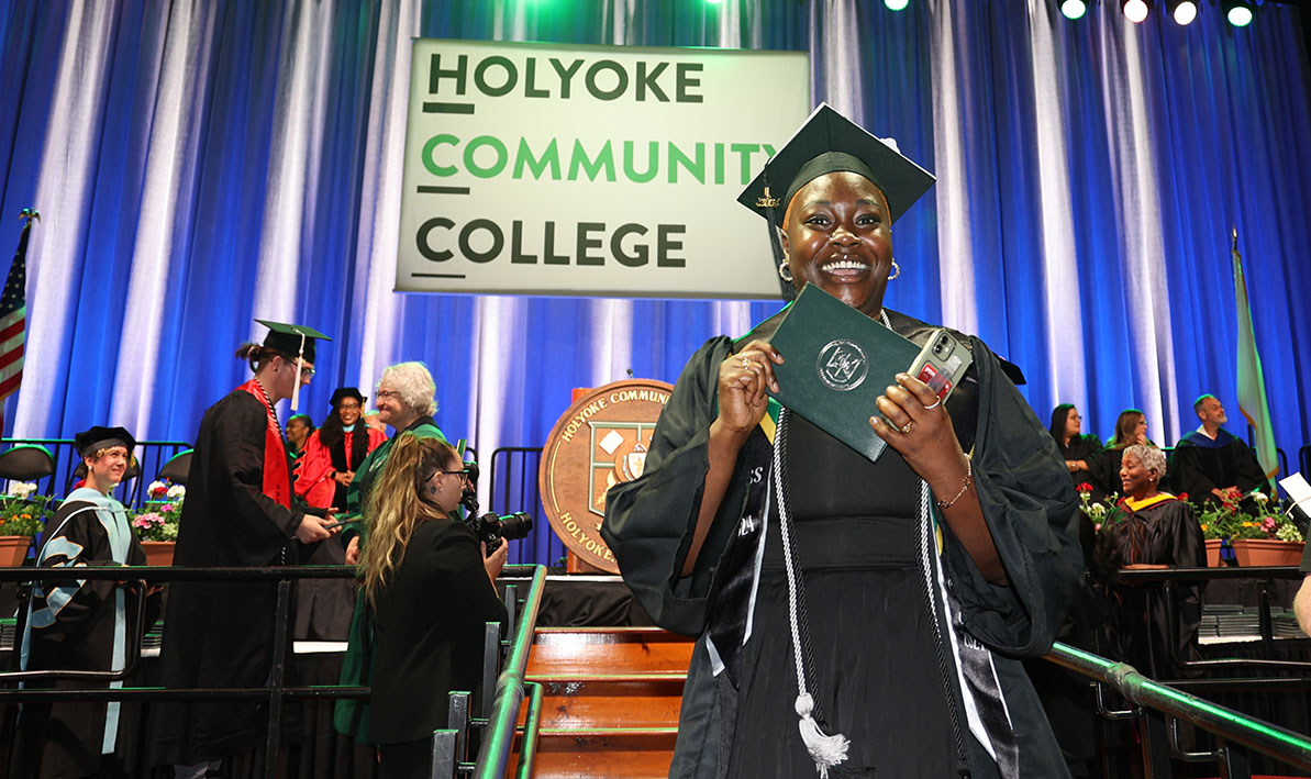 A grad celebrates at Commencement after receiving diploma