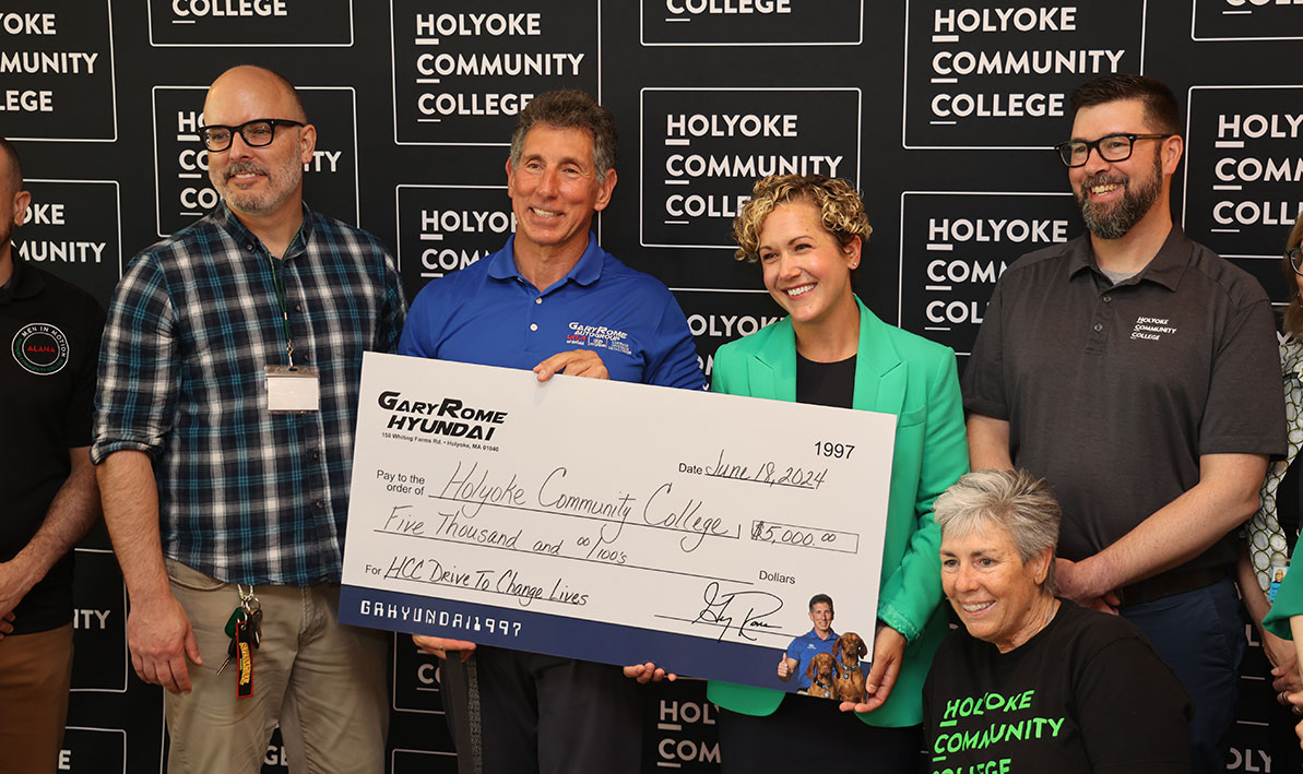 Gary Rome presents a $5,000 donation check to HCC
