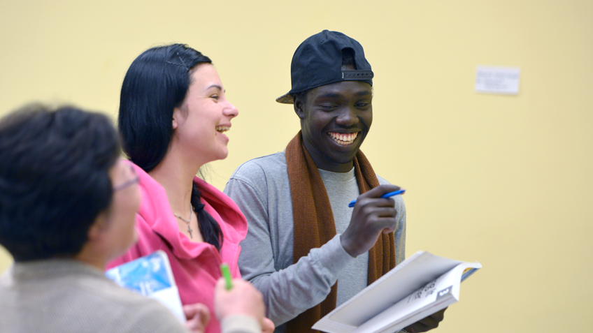 A group of students smiling and laughing together