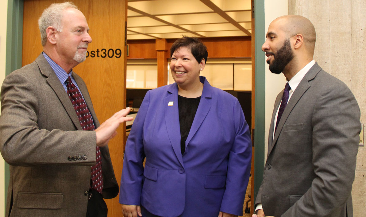 HCC trustee Evan Plotkin, left, and HCC president Christina Royal welcome Jose Delgado to his first Board of Trustees meeting.