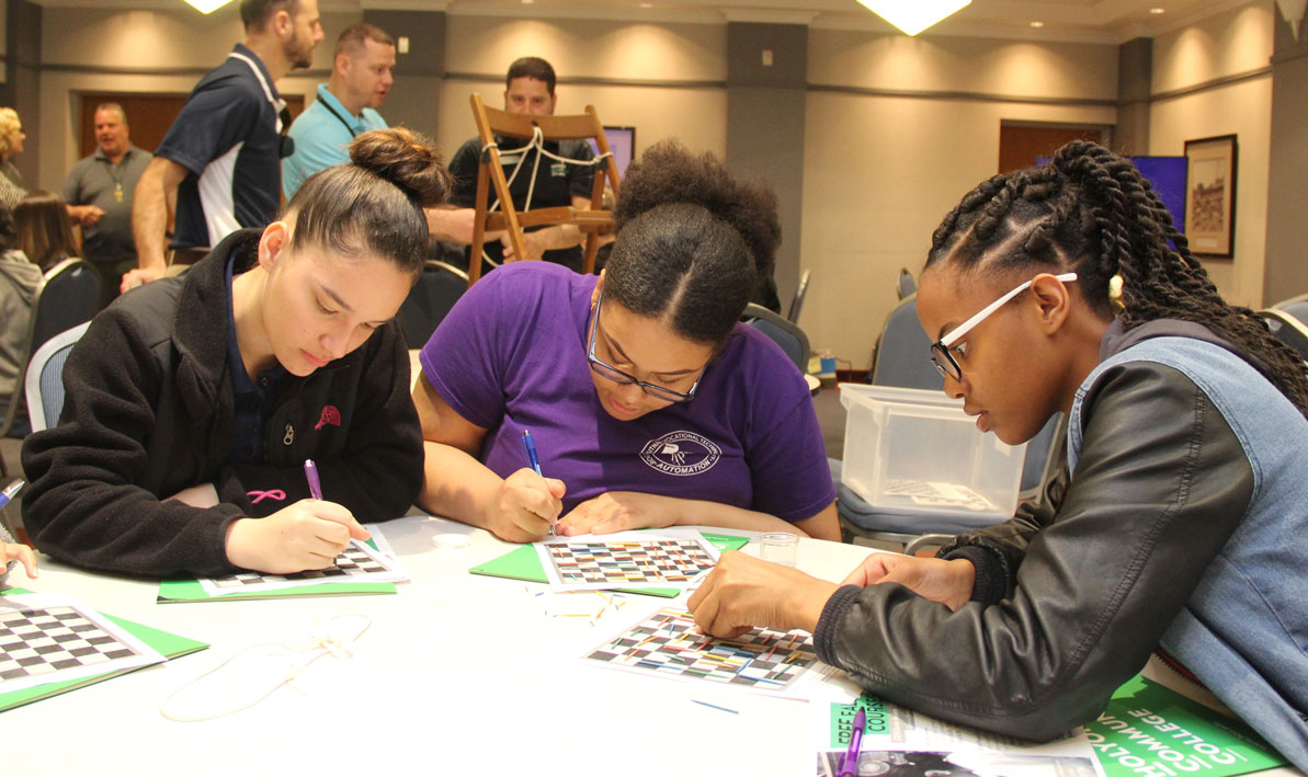 Students from Putnam Vocational High School try to figure out a logic puzzle. 