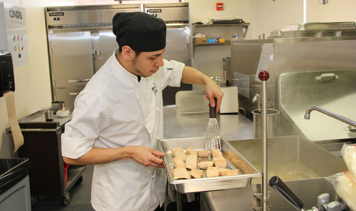 Michael Serrano prepares salmon fillets