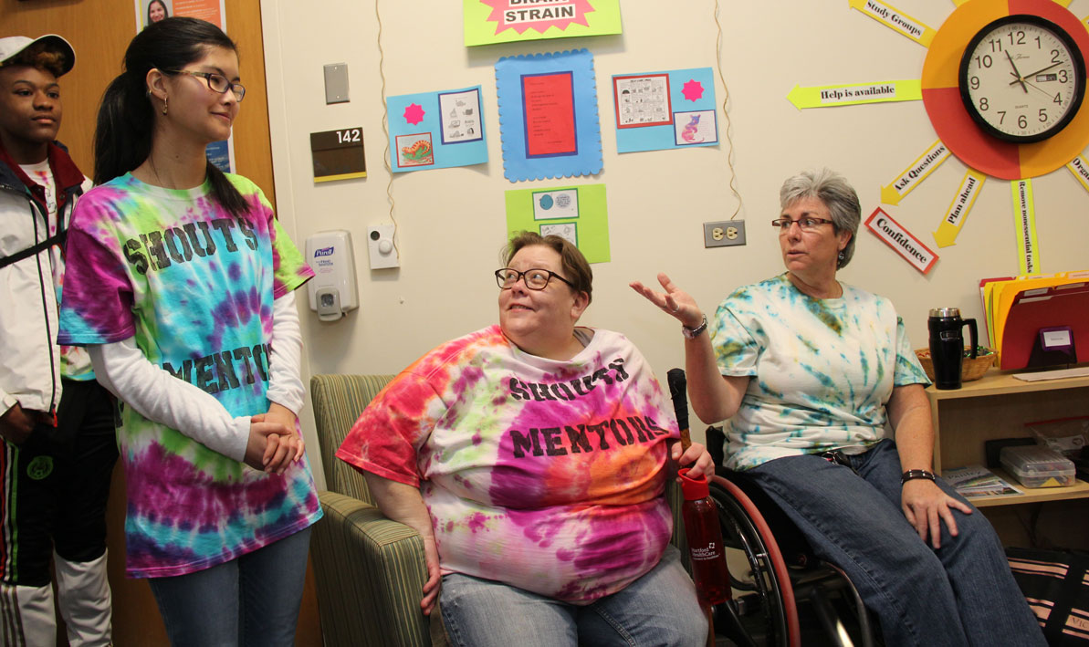 STRIVE adviser Denise Roy, right, talks with SHOUTS mentors Sue Lawrence, center, and Kiara Taylor during an open house at the new SHOUTS office.