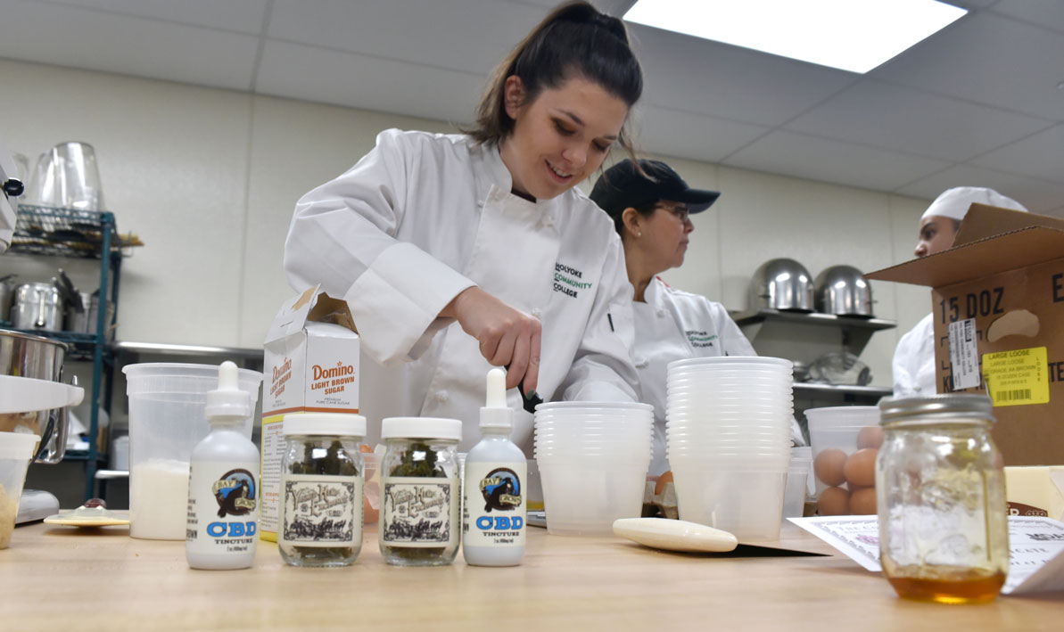 An instructor teaches students how to bake cookies using CBD oil extracted from hemp