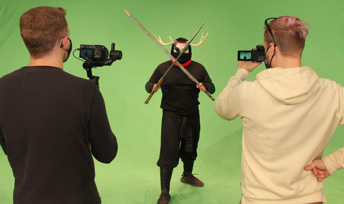 Director Tim Cochran, left, and alumni streaming coach Cory Missildine, right, videotape student actor Jose Colon for some fight sequences for the Fall 2020 HCC theater department production, Fatal Fisticuffs