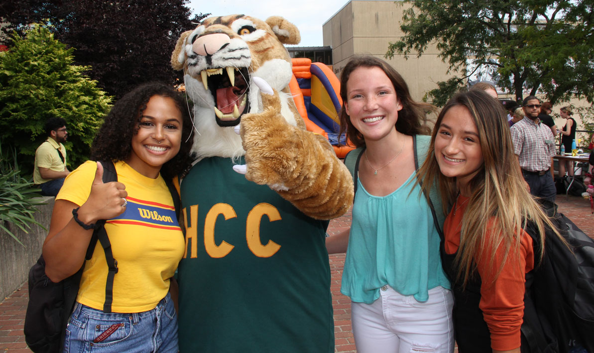 Group of happy looking HCC students in the courtyard