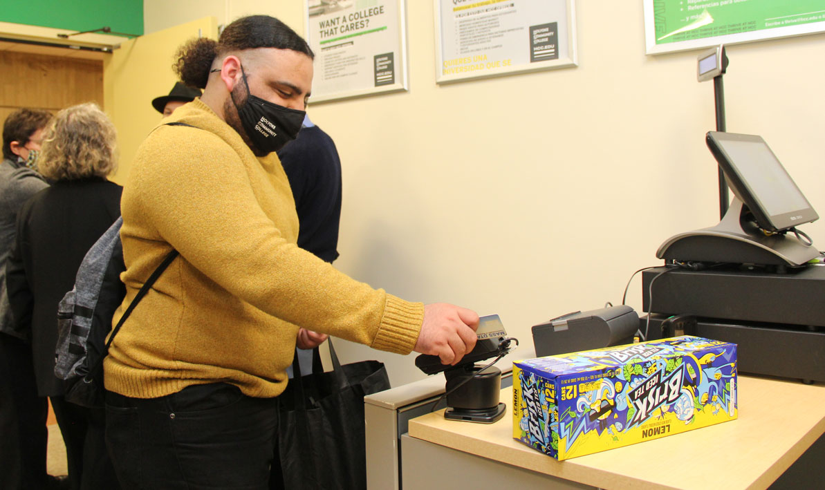 HCC student Luis Jimenez makes a purchase at HCC's Homestead Market