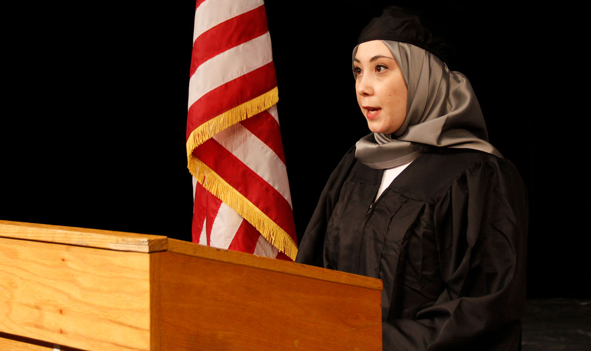 Graduating HCC student Tugce Kuruca delivers her speech for Commencemen6 2021 from the stage of HCC's Leslie Phillips Theater