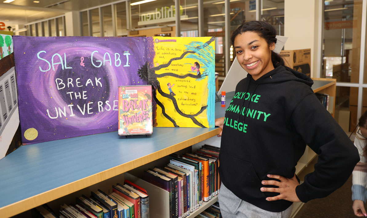 Barbara Ann Santiago stands by her children's book display at the Holyoke Public Library