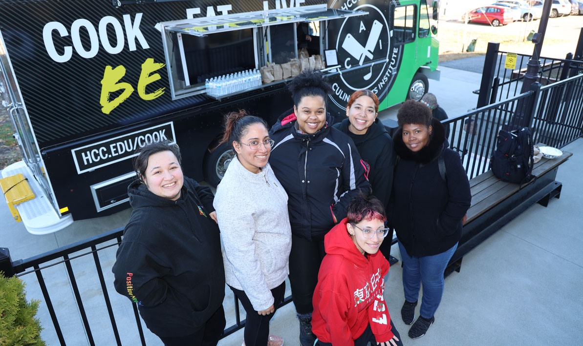 HCC Line Cook students at the HCC MGM Culinary Arts Institute stand by the new HCC Culiary Arts food truc,. 