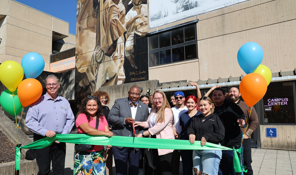 HCC staff and students cut a green ribbon