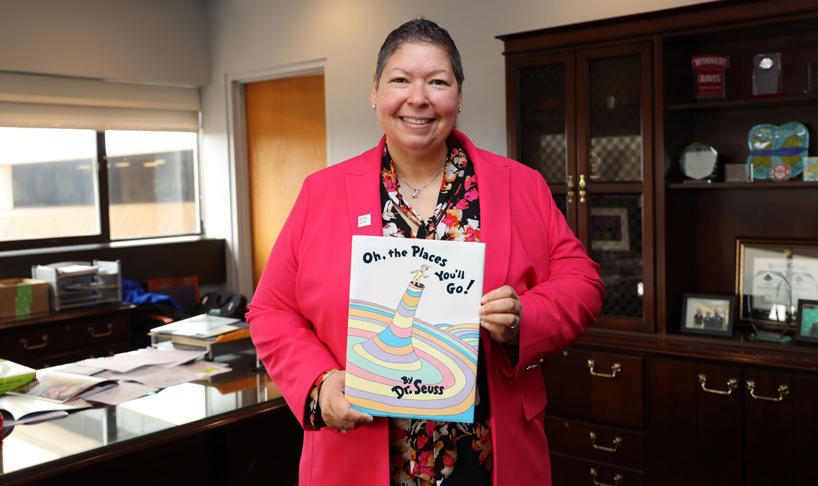 Retiring HCC president Royal holds one of her favorite books