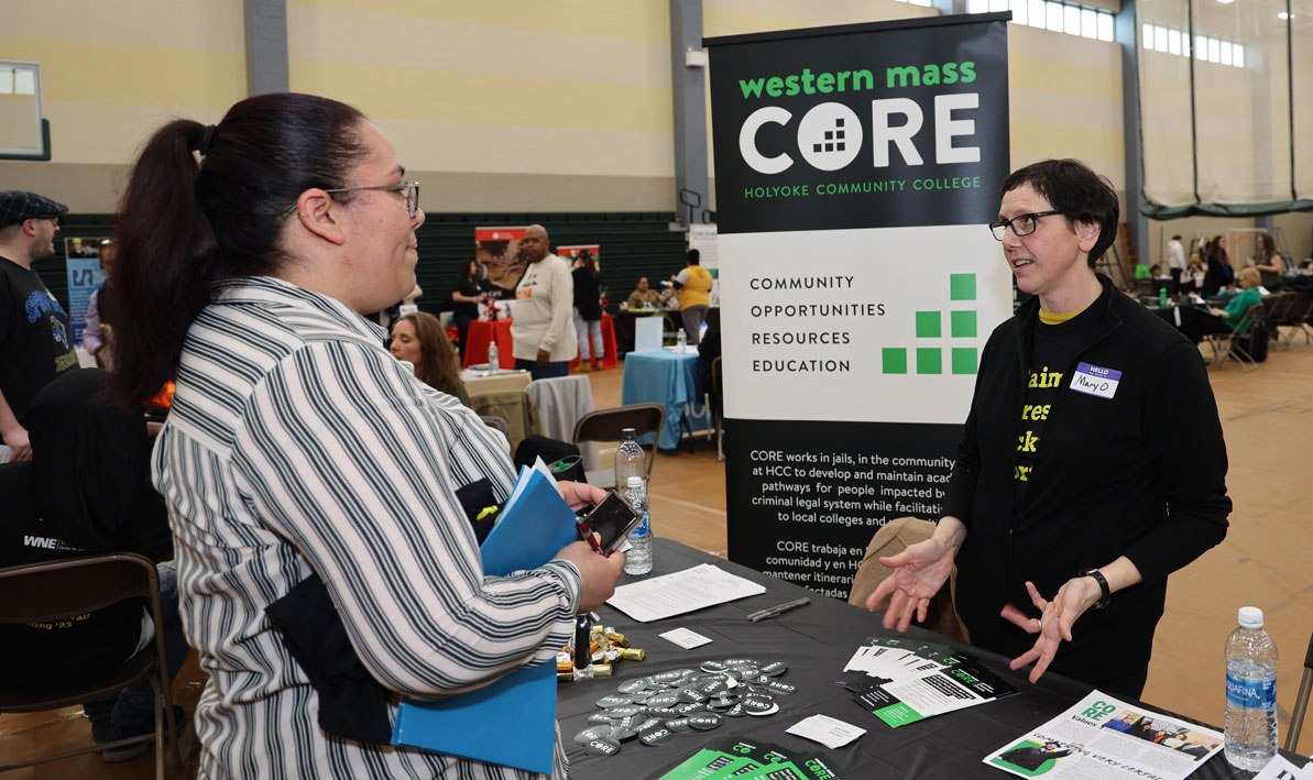 HCC economics professor Mary Orisich talks to a fair attendee