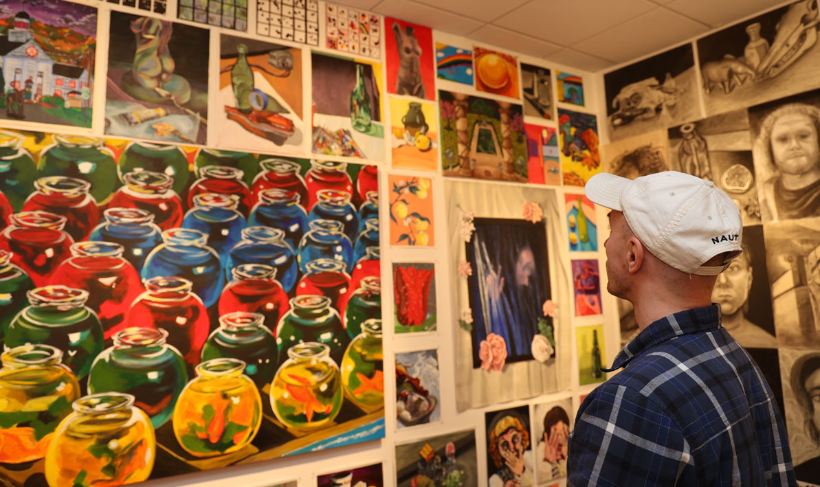 A student tours the Taber Art Gallery during the spring 2023 Student Art Exhibition.