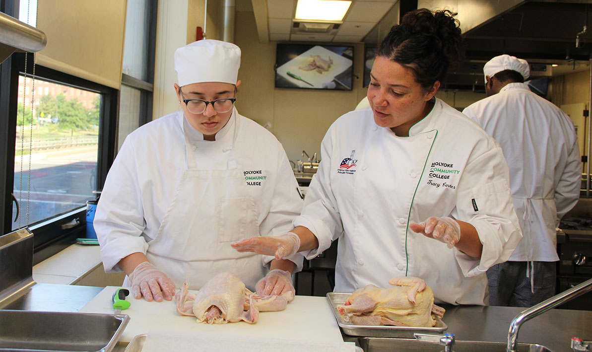 Chef Tracy Carter helps a culinary arts student during a class.