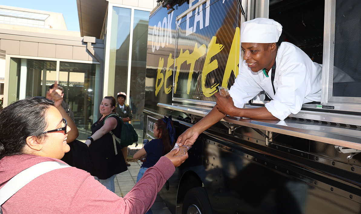 Culinary arts students Kendra Edwards hands out free chocolate chip cookies from the Culinary Arts Truck during STEM Week.