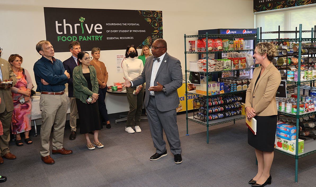 President George Timmons welcomes guests to the college's new food pantry. ntry.