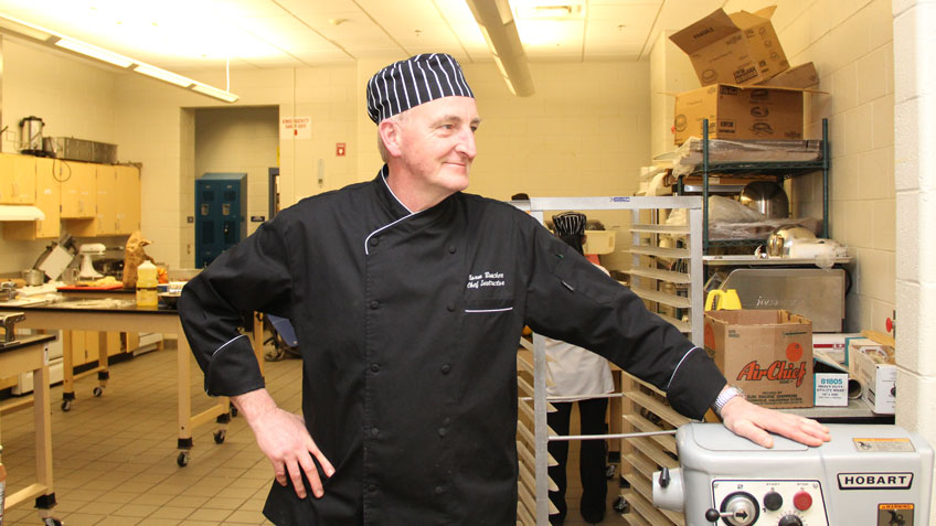 Norman Boucher standing in a kitchen