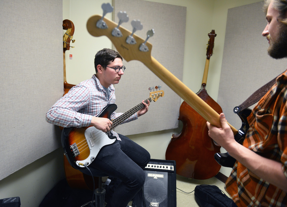 Two students playing electric guitar