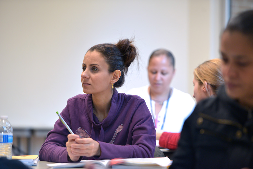 A female student holds a pen in class