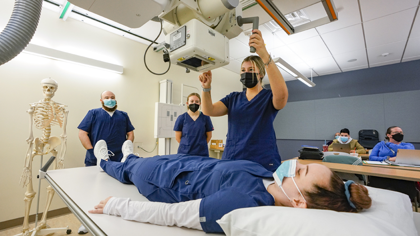 Radiologic technology students use an X-ray machine