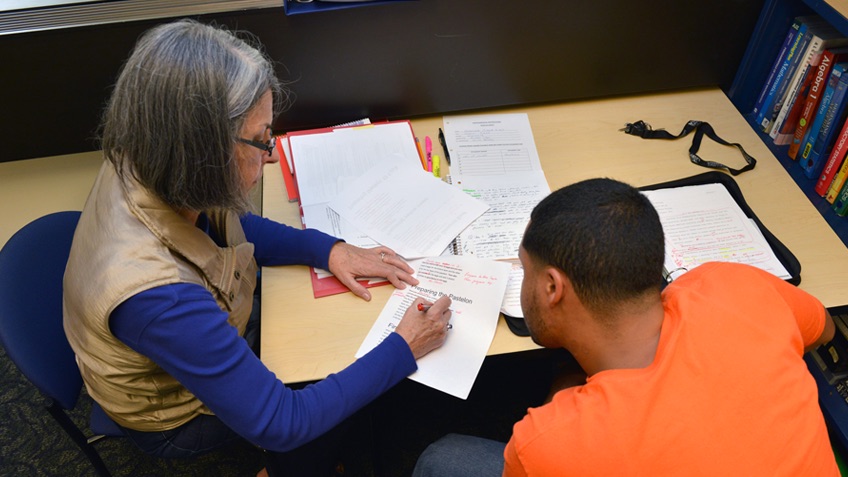 An advisor works on a paper with a student