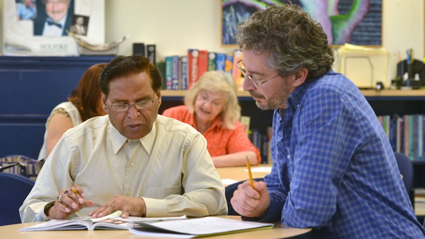 A tutor working with an adult student