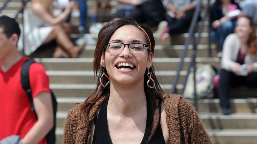 Smiling female student outside on the Holyoke Community College campus