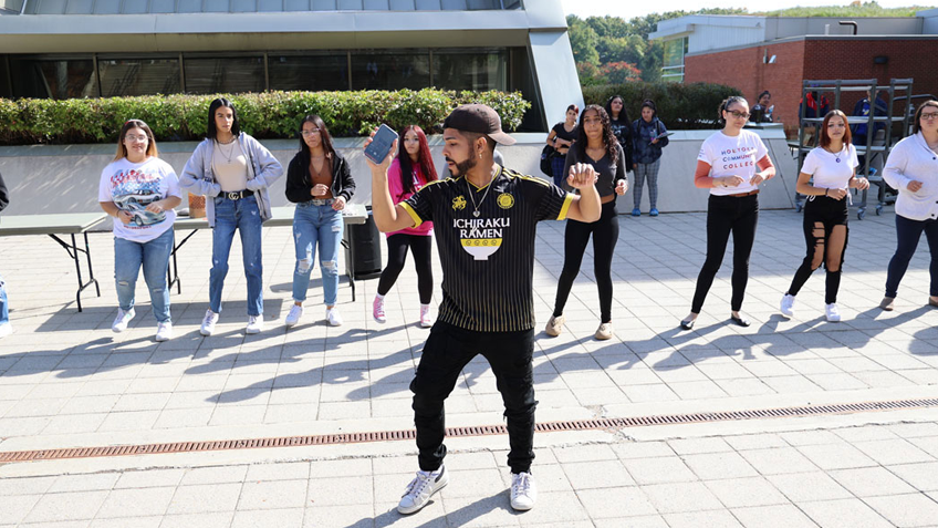 A student dances the Bachata in the HCC courtyard