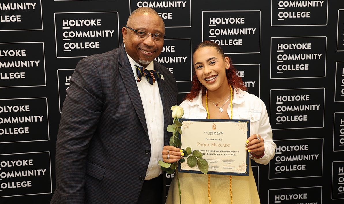 President George Timmons and new Phi Theta Kappa inductee Paola Mercada of Springfield